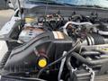 The image shows the engine compartment of a 2015 Ford F-550 featuring various components including the air filter housing battery cables and fluid reservoirs