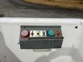 A control panel with buttons labeled for various functions including position and output along with color-coded buttons in red blue and green