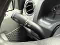 A close-up view of the control stalk inside a 2019 Ford Econoline featuring symbols for windshield wipers and headlights