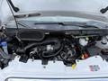The engine compartment of a 2022 Ford Transit showing the engine and various mechanical components