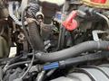 Close-up of the engine compartment of a 2014 International TerraStar showing various components like hoses wires and caps