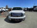 A white 2012 Ford F-150 pickup truck with a chrome grille facing forward