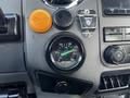 Dashboard of a 2011 Ford F-750 featuring an air pressure gauge with a range from 0 to 150 PSI and various control knobs and buttons