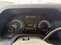 The dashboard of a 2010 Ford Econoline featuring speedometer, tachometer, fuel gauge, temperature gauge, and various warning lights