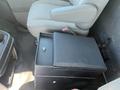 A black center console with a latch located between the front seats of a 2012 Chevrolet Express