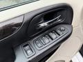 Dodge Grand Caravan door panel featuring window control buttons and a door handle
