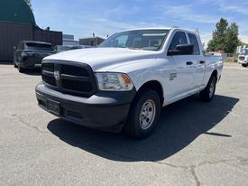A 2019 RAM 1500 Classic in white with a black grille parked at an angle showcasing its front and side view