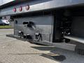 A 2021 Ford F-550 truck's rear view showing a black storage box with two large handles and a tow hitch underneath