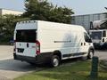 A white 2017 RAM Promaster van parked with its rear visible showcasing the sliding side door and rear doors