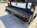 A 2023 Ford F-550 with a heavy-duty rear bumper featuring integrated lights and a compartment for equipment storage