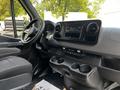 Interior view of a 2019 Mercedes-Benz Sprinter showcasing the dashboard features including a stereo system and cup holders