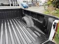 A 2012 GMC Canyon pickup truck with a black bed liner visible in the truck bed