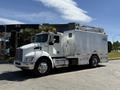 A 2009 Kenworth T270 truck with a white exterior featuring a service body and a mounted aerial lift system