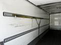 A 2019 International 4300 truck interior featuring a metal beam with an adjustable strap for securing cargo along the walls