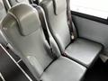 Interior seating of a 2013 International 4200 with two gray upholstered seats featuring safety belts