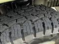 A close-up view of a rugged tire tread showcasing deep grooves and patterns on a 2004 Ford Econoline tire