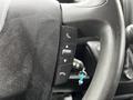 Close-up of the steering wheel controls of a 2021 RAM Promaster showing buttons for phone and menu functions