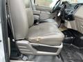 A 2010 Ford F-250 SD truck's interior showing two front seats with gray upholstery and a central console