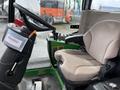 Interior view of a 2014 John Deere 1585 Terrain Cut showing the operator's seat and control panel with various levers and buttons