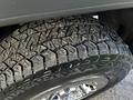 A close-up view of a tire from a 2017 GMC Sierra 1500 showing an aggressive tread pattern and shiny chrome rim