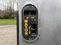 Control panel of a Maxon liftgate featuring buttons for operation and adjustment on a gray surface