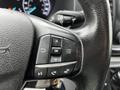 Close-up of the steering wheel controls of a 2021 Ford Transit featuring buttons for navigation and audio functions