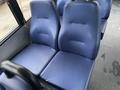 Two blue upholstered seats with a textured surface inside a vehicle