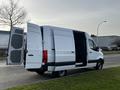 A 2022 Mercedes-Benz Sprinter van with double rear doors open revealing a spacious cargo area