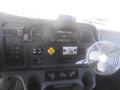 Dashboard of a 2005 Freightliner M2 106 Medium Duty truck with various controls and a small fan attached