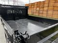 A 2019 Ford F-550 truck bed featuring a black interior with metal mesh dividing sections and a flat surface