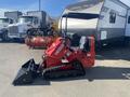 A red 2025 AGT Industrial SDA-140T(Z) compact snow groomer with tracks and a front-mounted plow blade