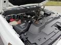 The engine compartment of a 2013 Chevrolet Silverado 3500HD showing the engine components and various fluids in their respective reservoirs