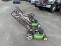 Three Honda Lawnboy mowers and two Stihl line trimmers are lined up in the foreground
