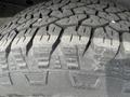 Close-up of a heavy-duty tire tread from a 2009 Ford Econoline showcasing deep grooves and rugged design for improved traction and durability