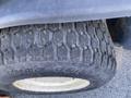 Close-up of a tire from a 2010 Kubota F3680 featuring a rugged tread pattern and visible wear on the surface