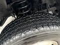 Close-up of a rugged tire showing deep tread patterns with visible wear indicating usage typical for a heavy-duty truck like a 2013 RAM 3500