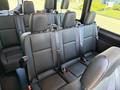Interior of a 2023 Mercedes-Benz Sprinter featuring multiple black leather seats with seat belts in a row
