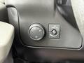 The dashboard controls of a 2013 Chevrolet Express including the headlight switch and the dome light switch
