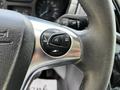 Steering wheel control buttons of a 2015 Ford Transit featuring buttons for audio and phone functions
