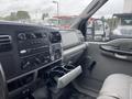 Interior view of a 2005 Ford F-350 SD with a dashboard featuring audio controls air conditioning vents and a center console cup holder