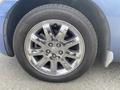 A close-up of the chrome alloy wheel of a 2007 Chrysler PT Cruiser featuring a tire with visible tread pattern and the brand name General on the sidewall