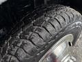 Close-up of a tire on a 2017 Ford Econoline showing a rugged tread pattern with dirt and debris on the surface