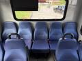 A 2020 Chevrolet Express with blue upholstered seats arranged in rows facing forward