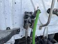 Two fuel hoses are connected to the rear of a 2022 Freightliner Cascadia with one hose being green and the other grey attached to metallic fittings