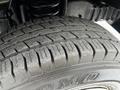 Close-up of a tire from a 2008 Ford Econoline showing detailed tread patterns and the brand name prominently displayed on the sidewall
