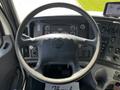 The interior view of a 2012 Freightliner M2 112 showing the steering wheel and instrument panel with various controls and gauges