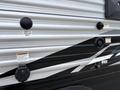 Close-up of the side exterior of a 2021 Jayco Jay Flight featuring various input and outlet connections including cable TV and satellite inputs