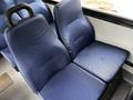 Two blue vinyl seats are positioned closely together with textured upholstery in a vehicle interior