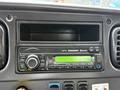 A truck stereo system with a digital display and various control buttons for tuning and media selection