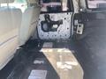Interior of a 2013 Ford Expedition showing stripped back seats and interior paneling with exposed wiring and flooring